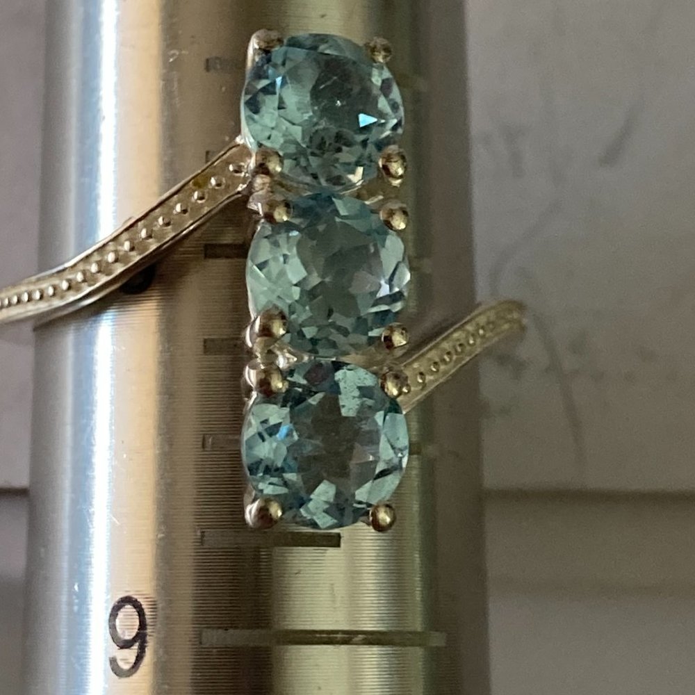 STS 3 faux aquamarine gems on bypass sterling silver setting
